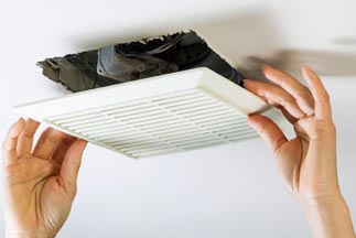 HVAC Technician installing a new ceiling vent — Air Conditioning Services in Dumfries, VA